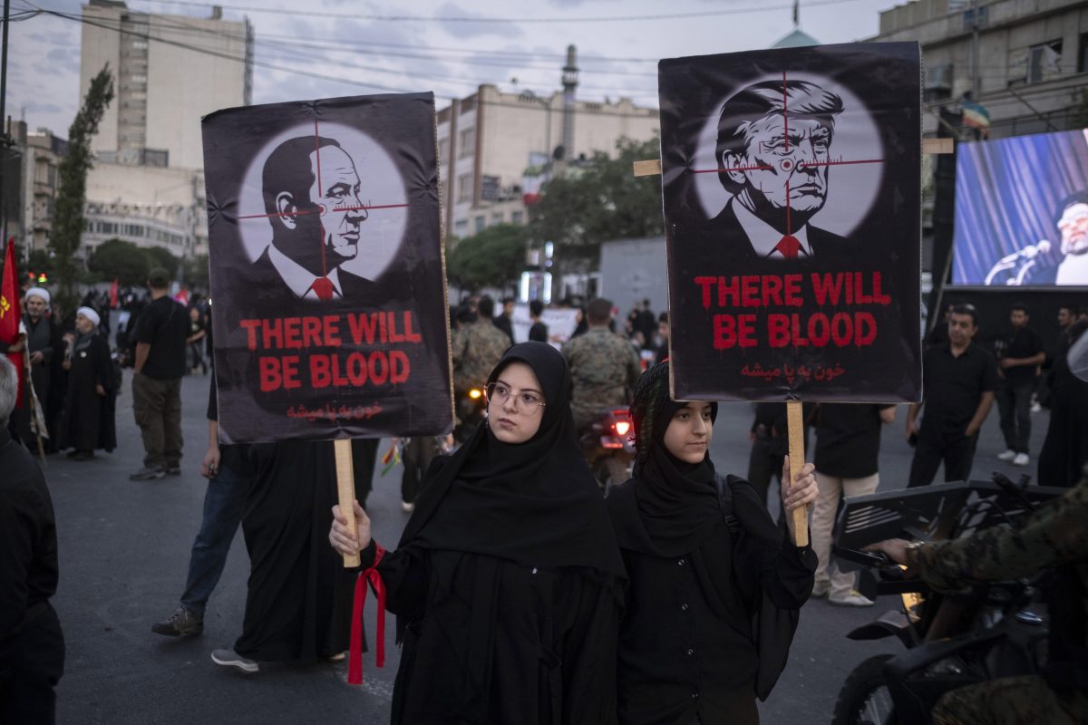 Female pro-government supporters carry placards with signs targeting U.S. President Donald Trump and Israeli Prime Minister Benjamin Netanyahu during the funeral for Iran's late Supreme Leader Ayatollah Ali Khamenei and his family in Tehran, Iran, on July 6, 2026. (Photo by Morteza Nikoubazl/NurPhoto)